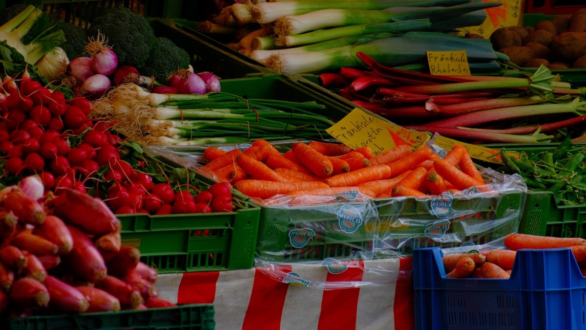 Fresh vegetables displayed at an outdoor market
