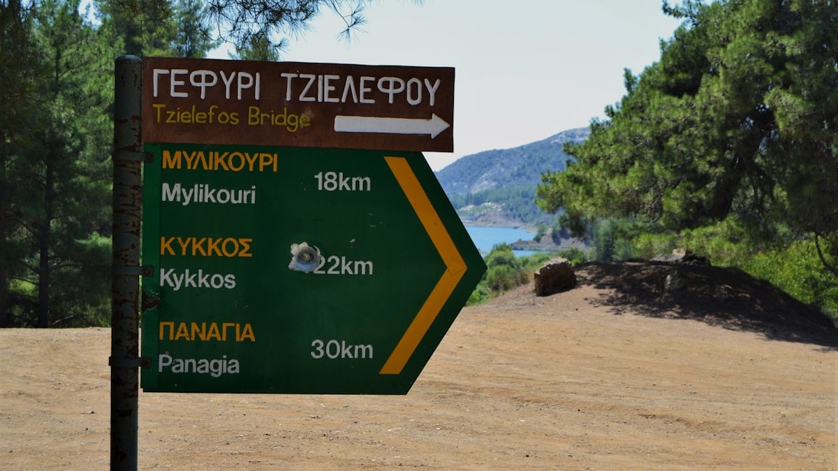 Signage with a shotgun pellet hole, Cyprus